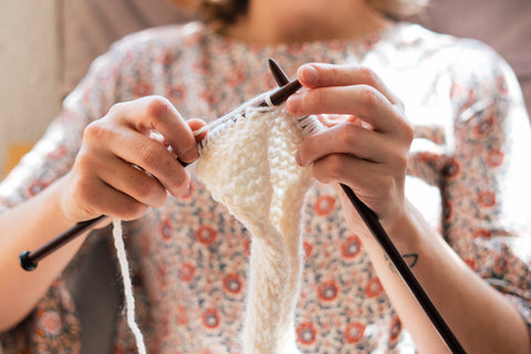 Woman knitting up close; photo courtesy of Pexels