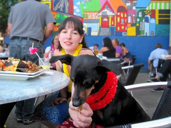 Lady feeding a dog in Double Wide Grill restaurant