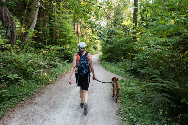 Lady hiking with a dog