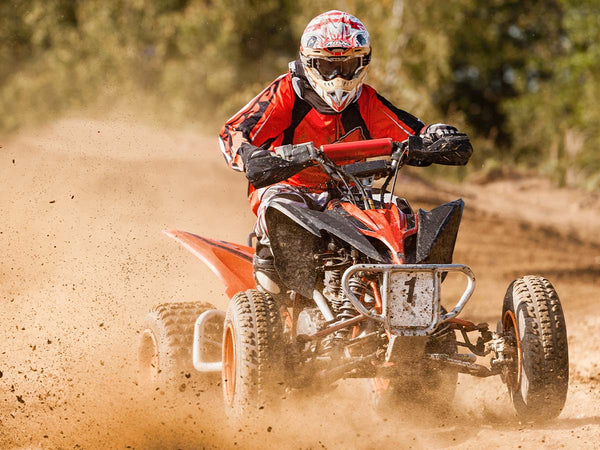 Image of a person off-roading in an ATV.