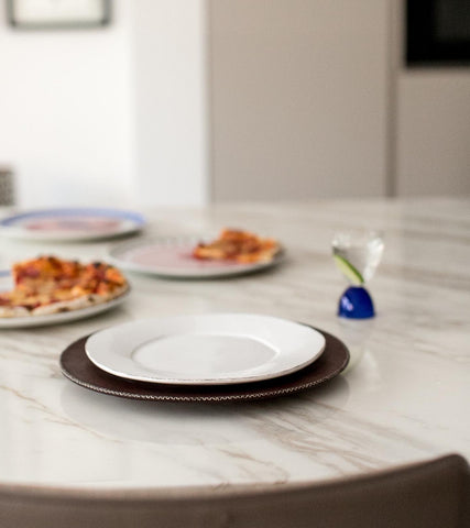 A picture of a plate on a dining table.