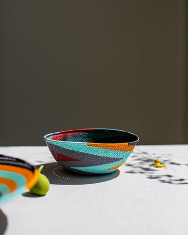 A picture of colorful serveware handmade of durable telephone wire.