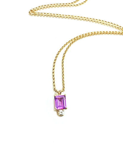 A redesign pendant necklace featuring an emerald cut amethyst and round diamond