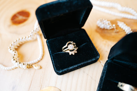 Custom wedding ring trio featuring the clients own diamonds bezel set in 14k yellow gold.