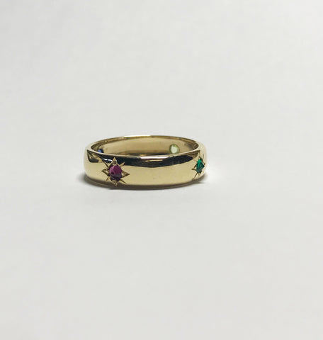 A custom family ring in 14k yellow gold featuring star-set birthstones