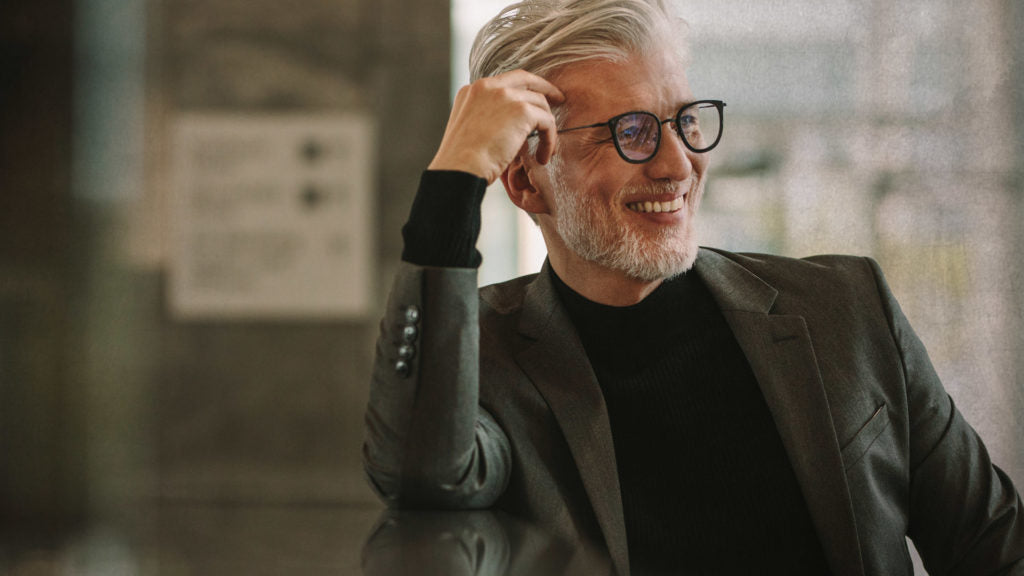 Man in suit smiling sideways