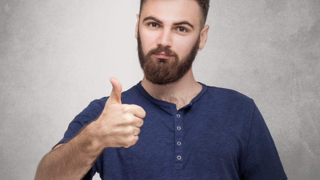 Bearded man giving a thumbs up sign