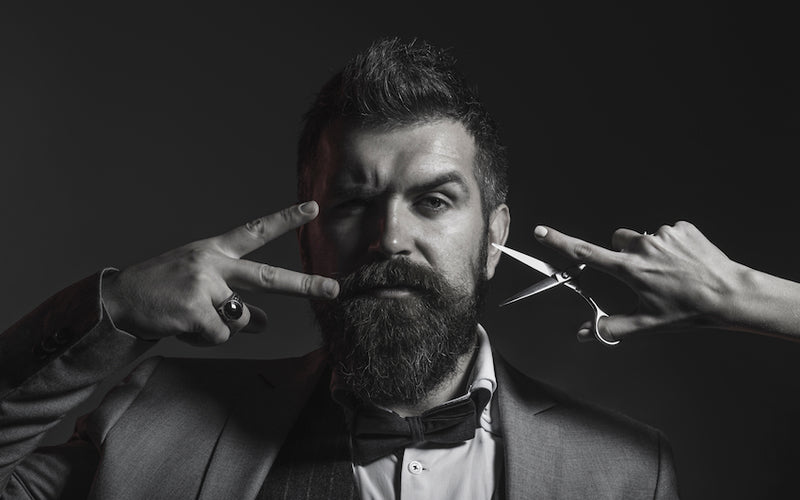 bearded man in suit and scissors