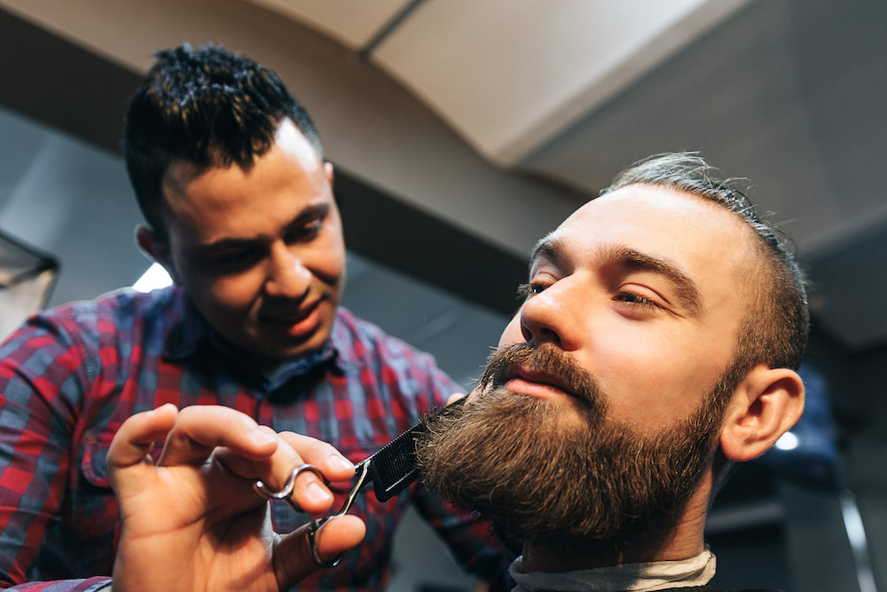 man getting a beard trim in salon