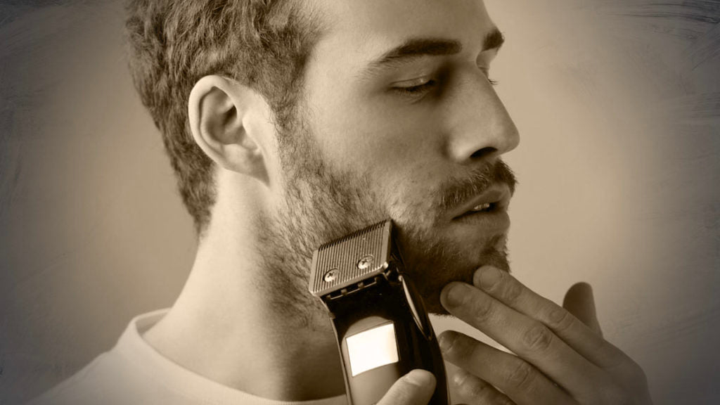 man trimming his beard