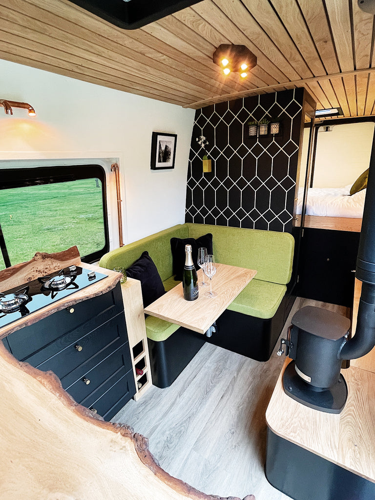 Campervan Interior with sofa, kitchen, shower and bed  