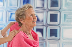 Elderly woman being cared for in the bathroom