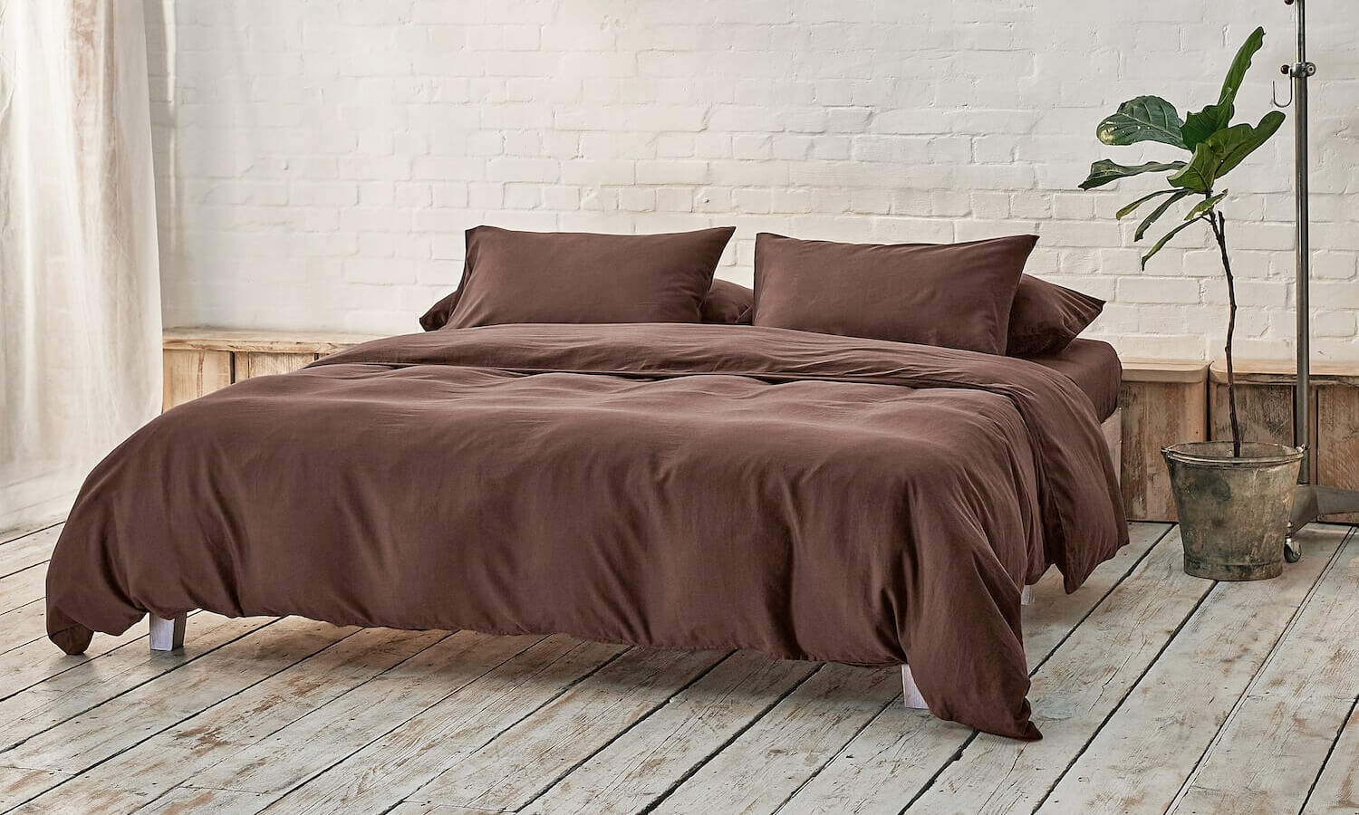dark brown bedding on bed in a modern room