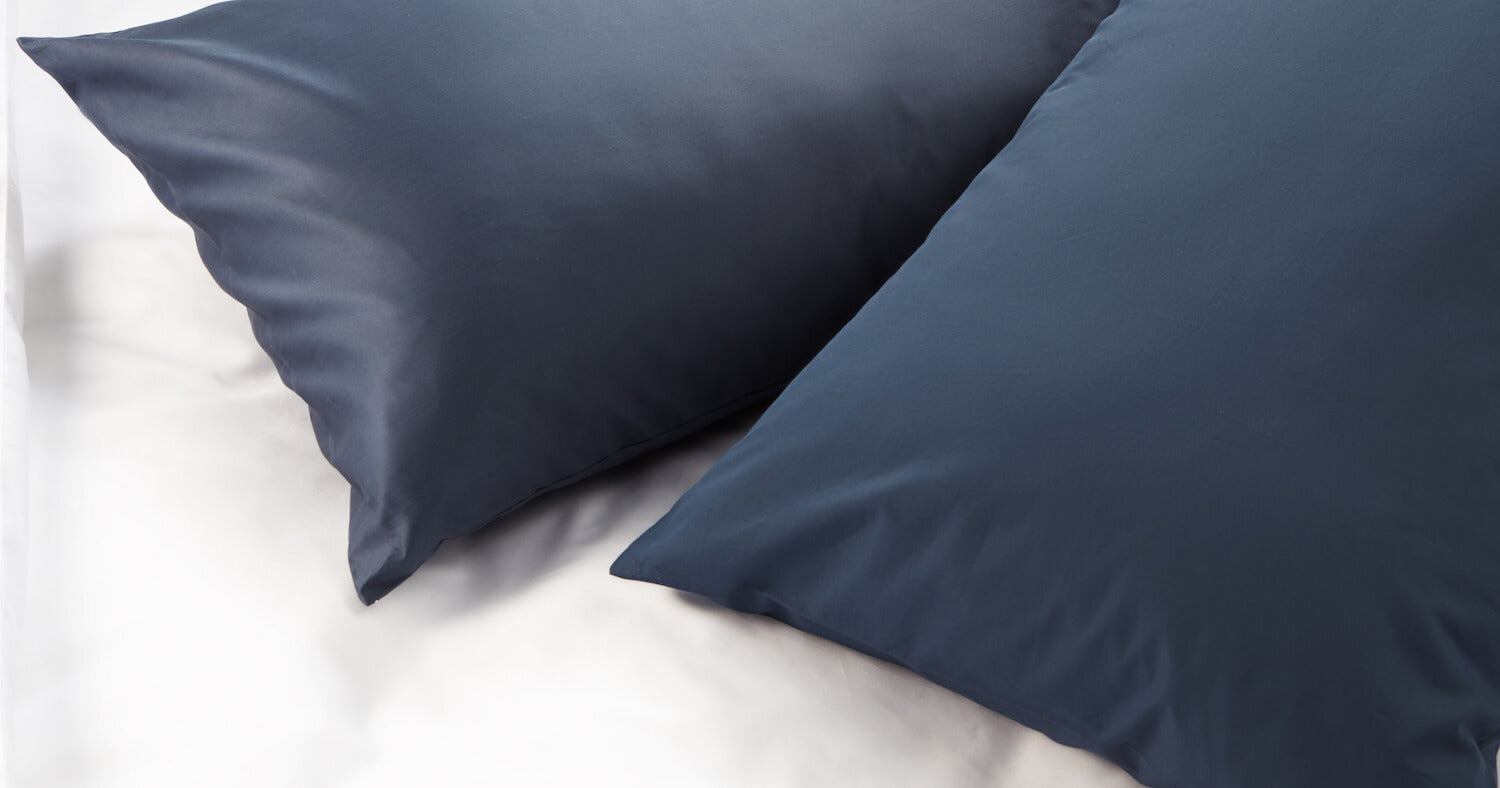 comparison of percale and sateen textures on navy pillowcase