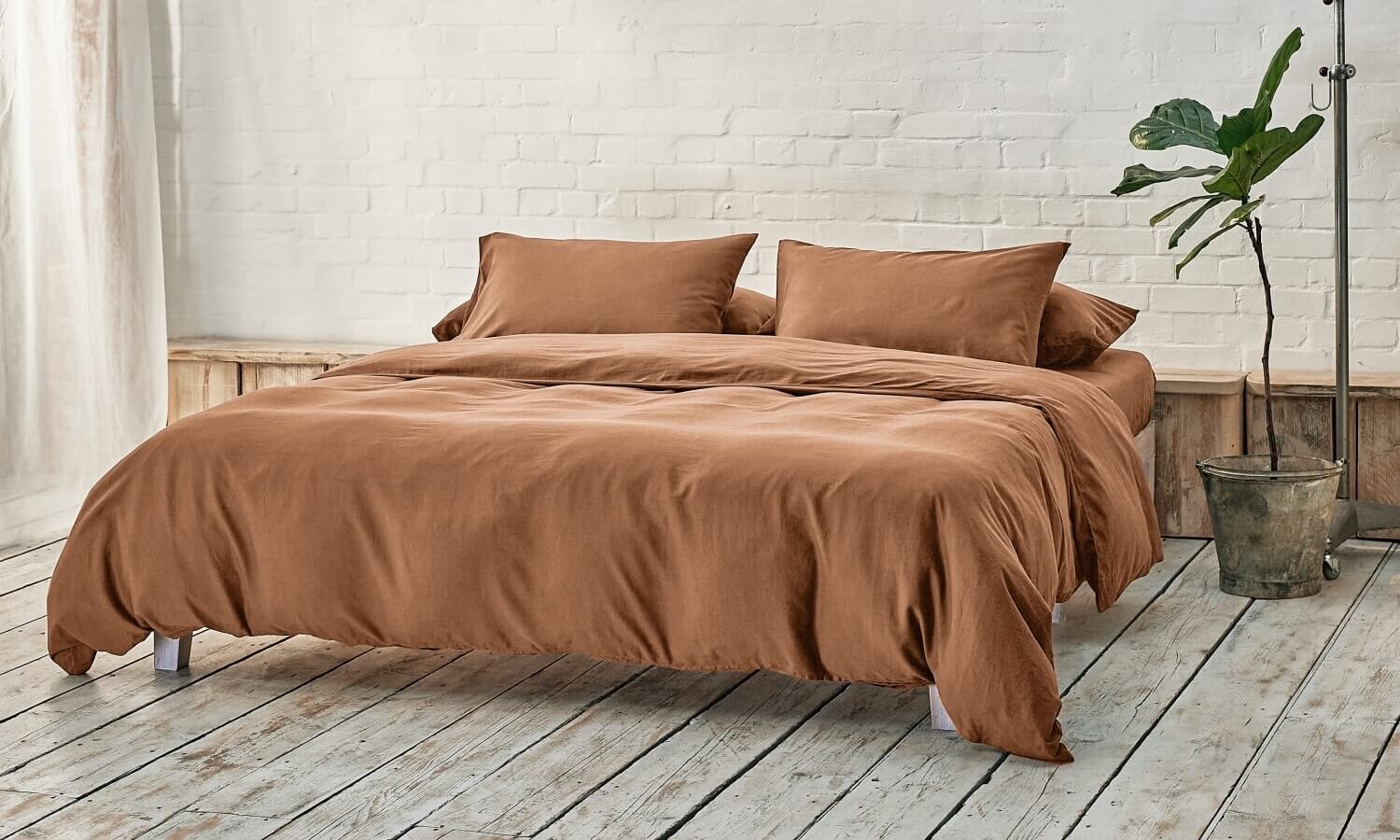 caramel brown bedding on bed in a modern room