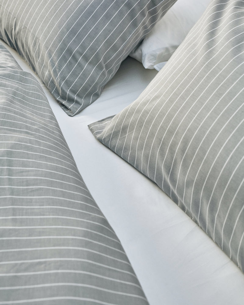 white and grey cotton bedding