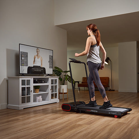 Woman walks on the treadmill