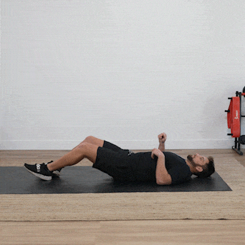 Man demonstrating knees to chest exercise