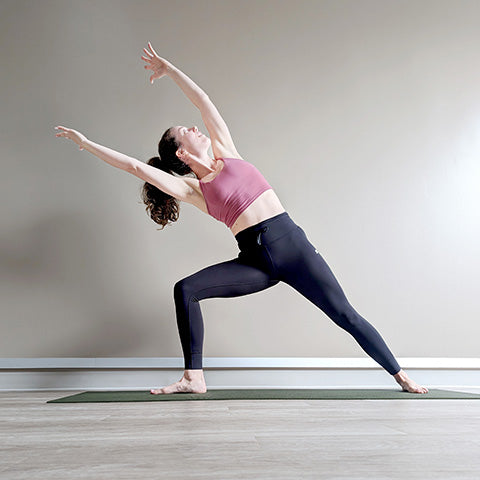Woman demonstrating Extended Side Angle (Utthita Parshvakonasana) exercise