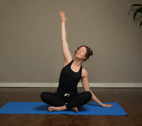 Woman demonstrating Easy Pose With Side Body Stretch exercise
