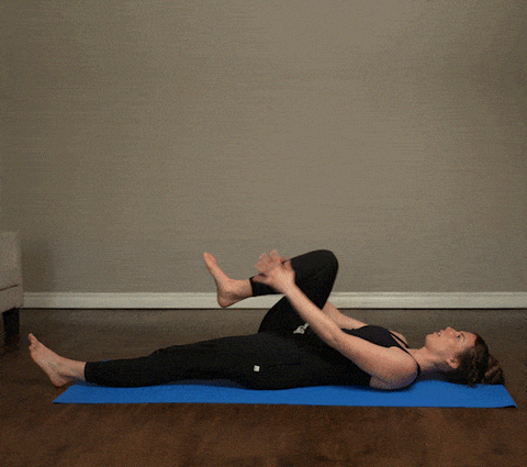 Woman demonstrating Spinal Twist exercise