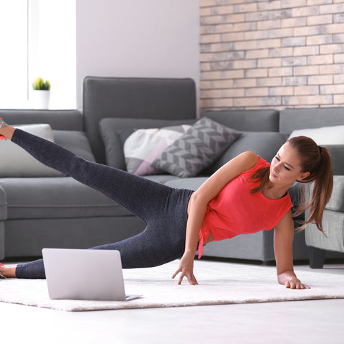 a woman is doing exercise in living room