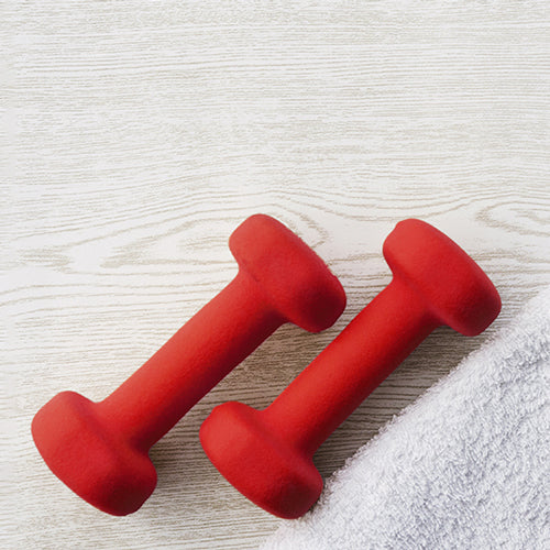 red dumbbells with a white towel