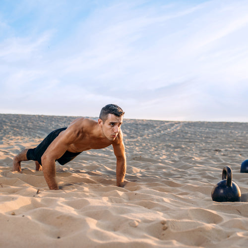 a man is pushing up on beach