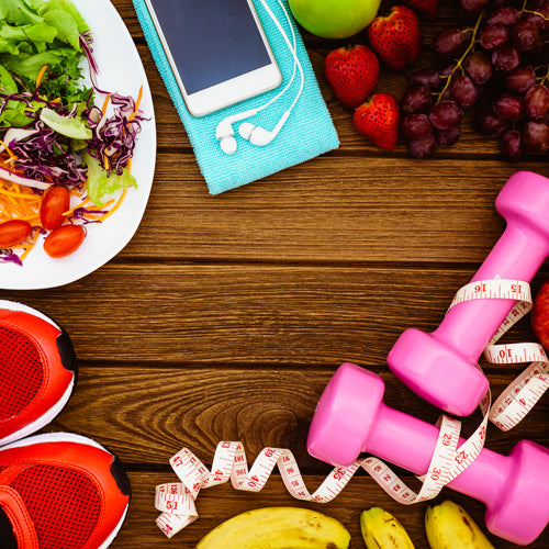 a plate of salad, a phone, shoes, fruits, and pink dumbells