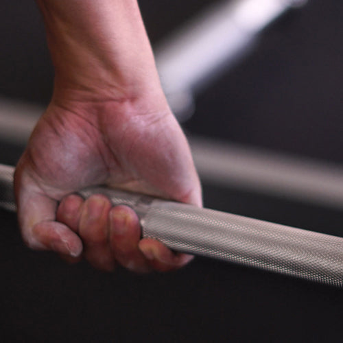 a hand is holding barbell