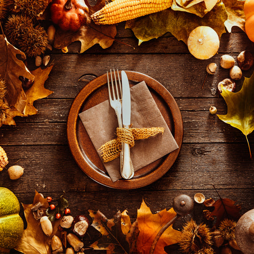 a bowl with knife and fork on a fall feeling decorated table
