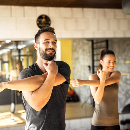 a man and a a woman are stretching