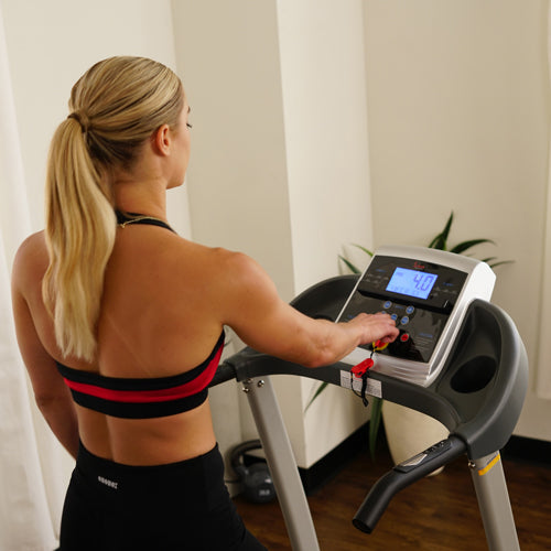 a woman is using treadmill control board