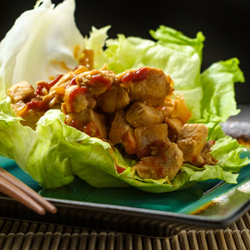 chicken lettuce wrap on a plate with chopsticks