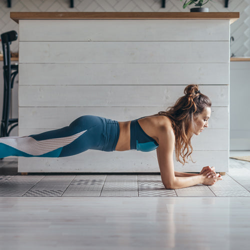 a woman is planking at home