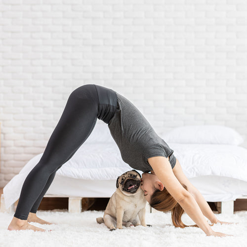 a woman is working out with her dog