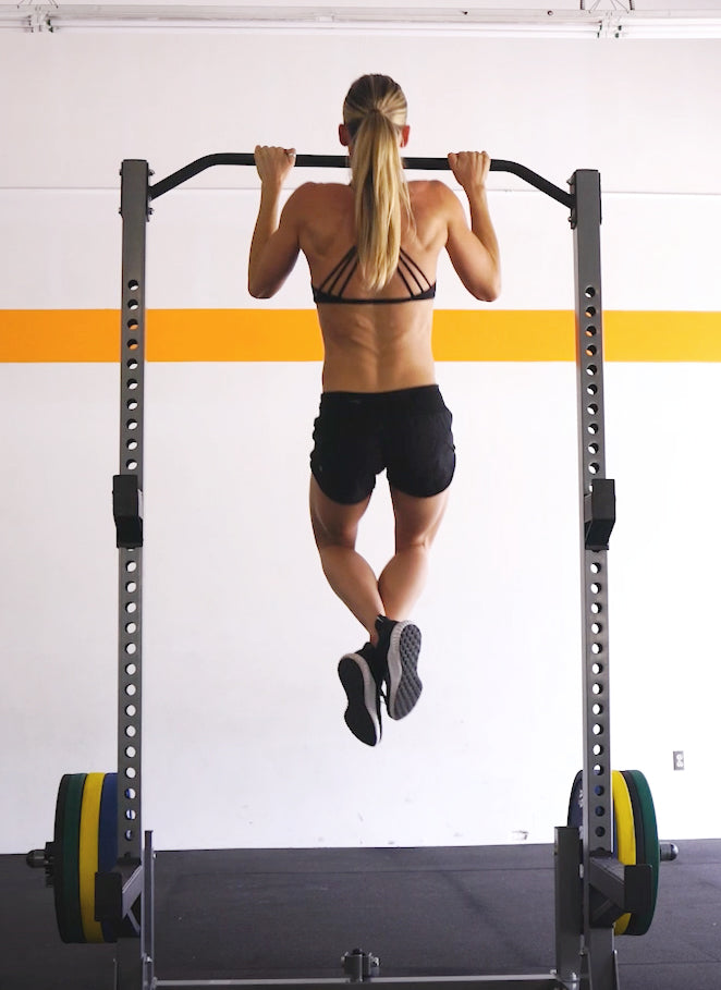 woman performing a pull up
