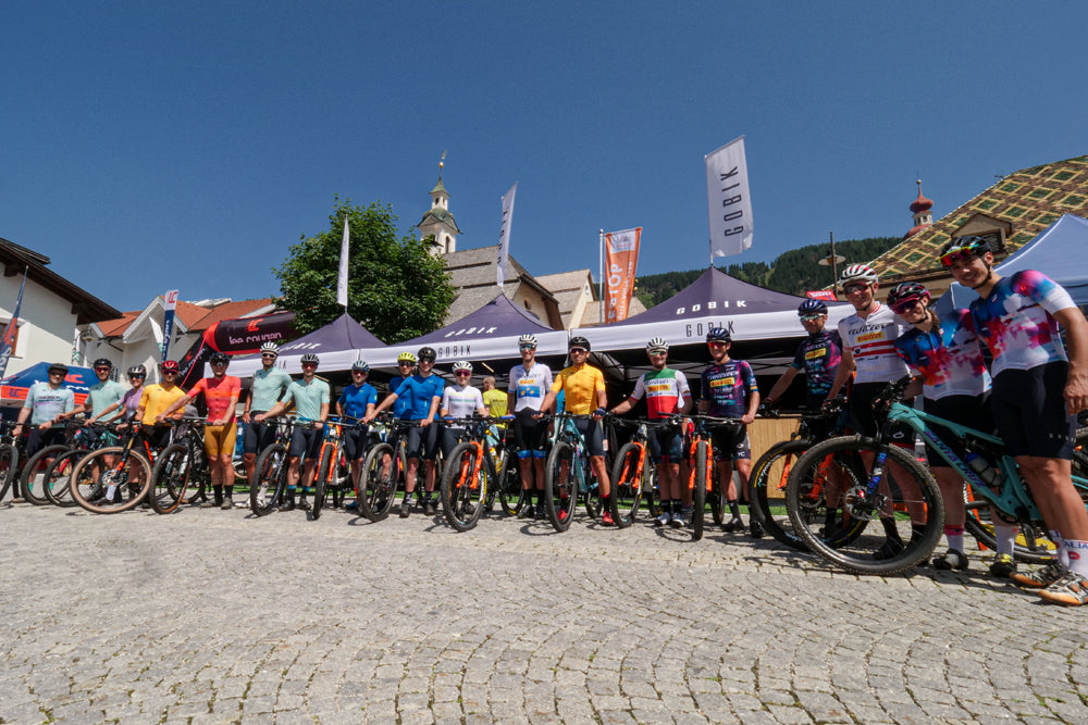 Participants of the social ride pose in front of the tents of the Gobik with the stars of the Willier Pirelli before the start of the ride. Everyone with their bikes and equipment Gobik.