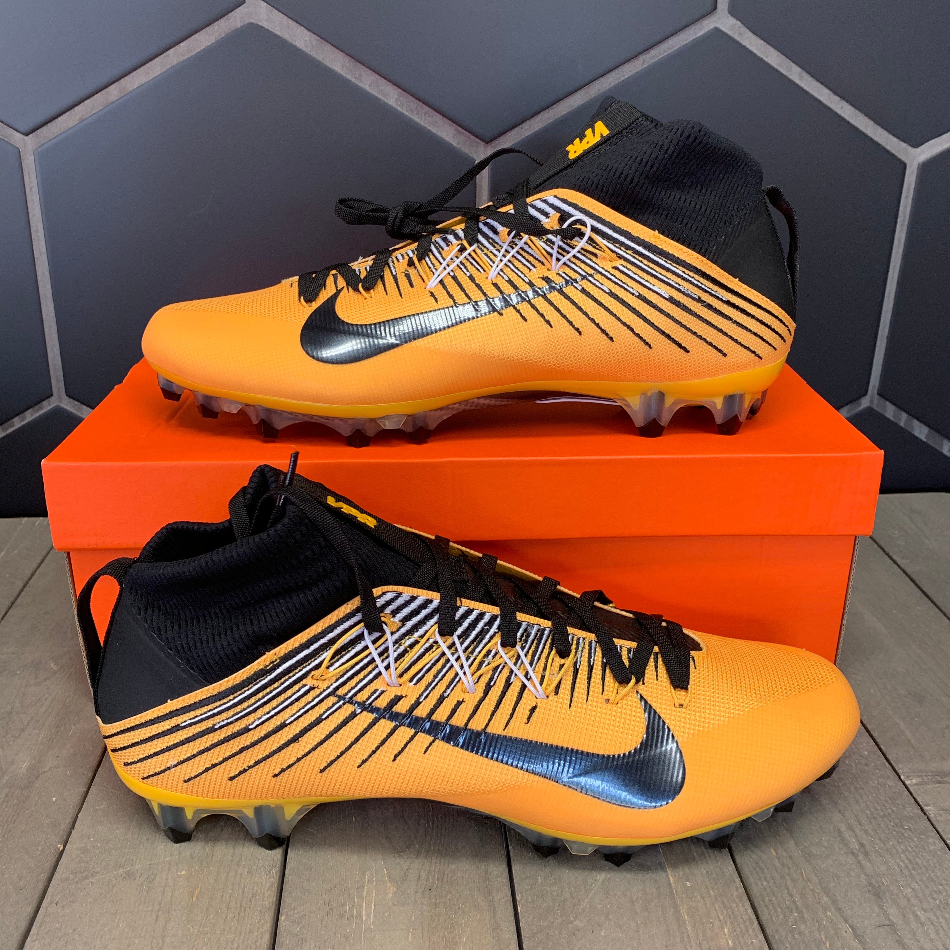 black and gold nike cleats