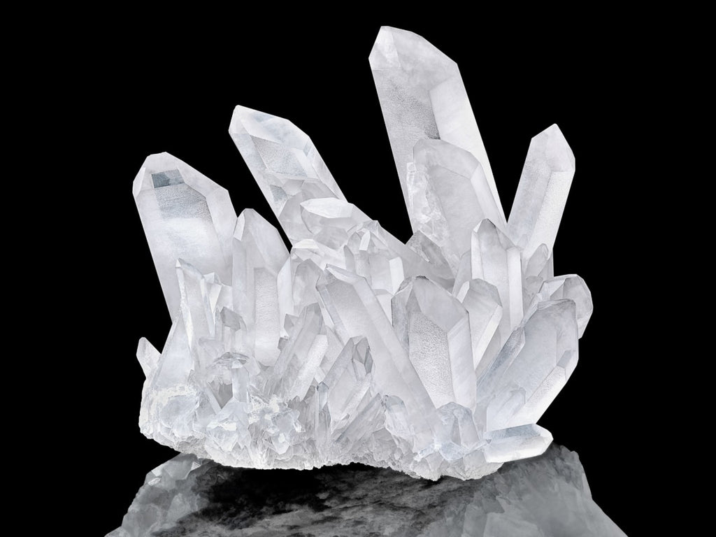Clear quartz on top of a rock.