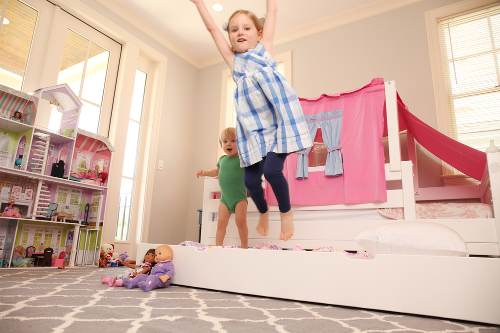 kids jumping on trundle bed