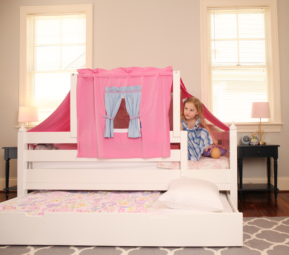 girl peaking out of toddler tent bed