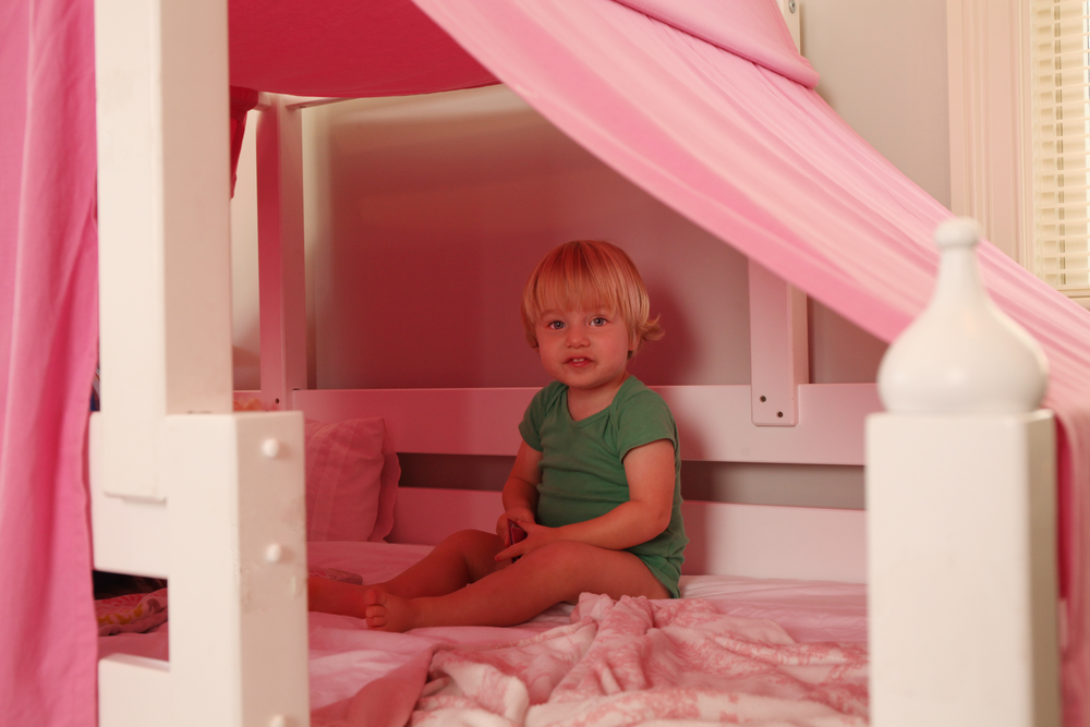 twin sitting in top tent bed