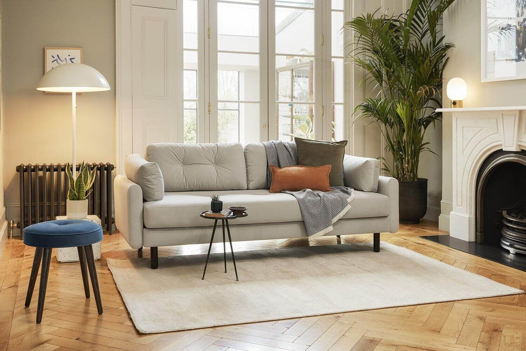 Living room with grey sofa and rug in front of window