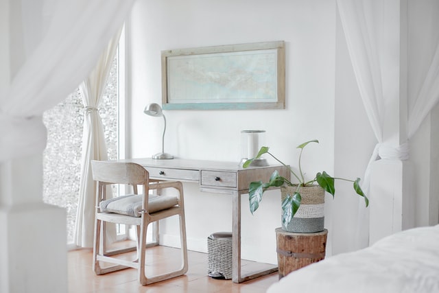 Wooden desk in white bedroom