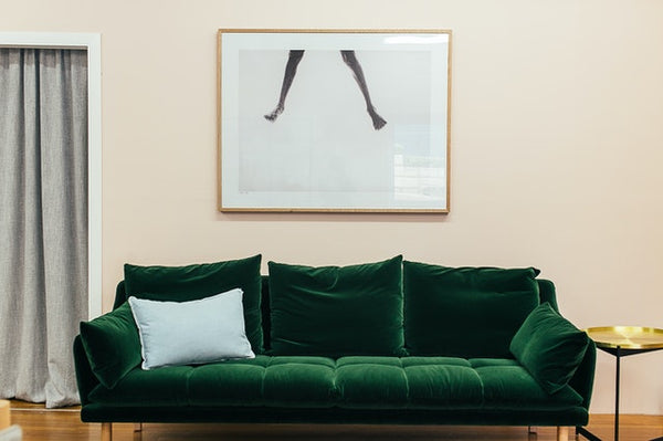 Green sofa with loose cushion