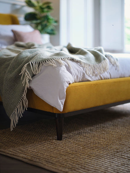 throw blanket on yellow velvet bed