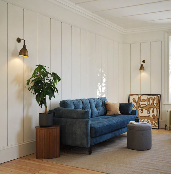 blue sofa with white panelled walls