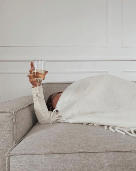 Person on sofa with wine glass