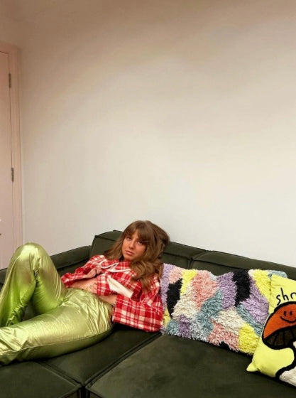 Person sitting on green sofa